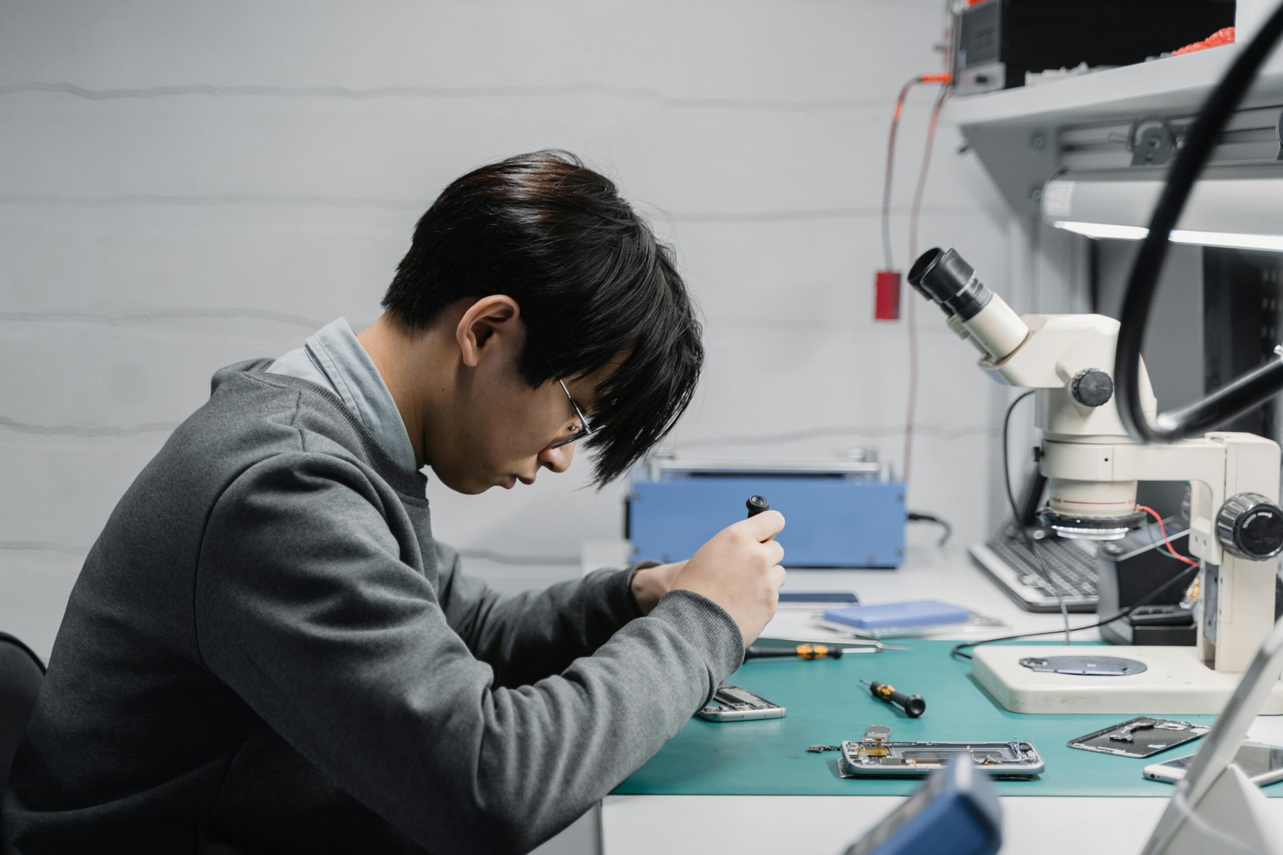 Mobile repair technician fixing smartphone